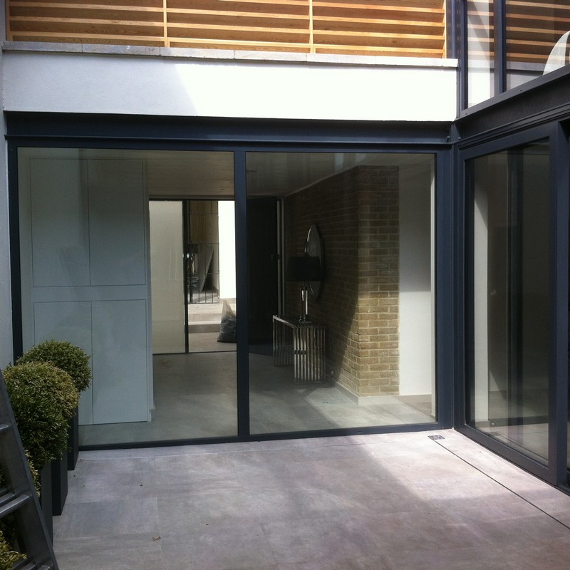Floor-to-ceiling sliding doors opening to courtyard in Hounslow