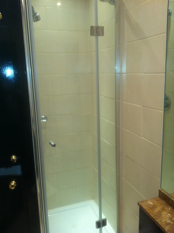 Frameless glass shower enclosure with chrome fittings in Hounslow