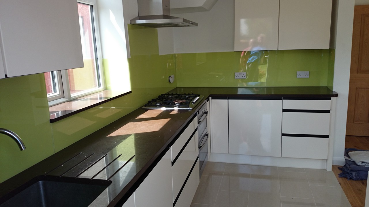 Lime green glass kitchen splashback installed by Hounslow glaziers