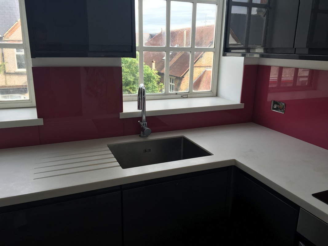 Deep plum coloured glass splashback in modern Hounslow kitchen